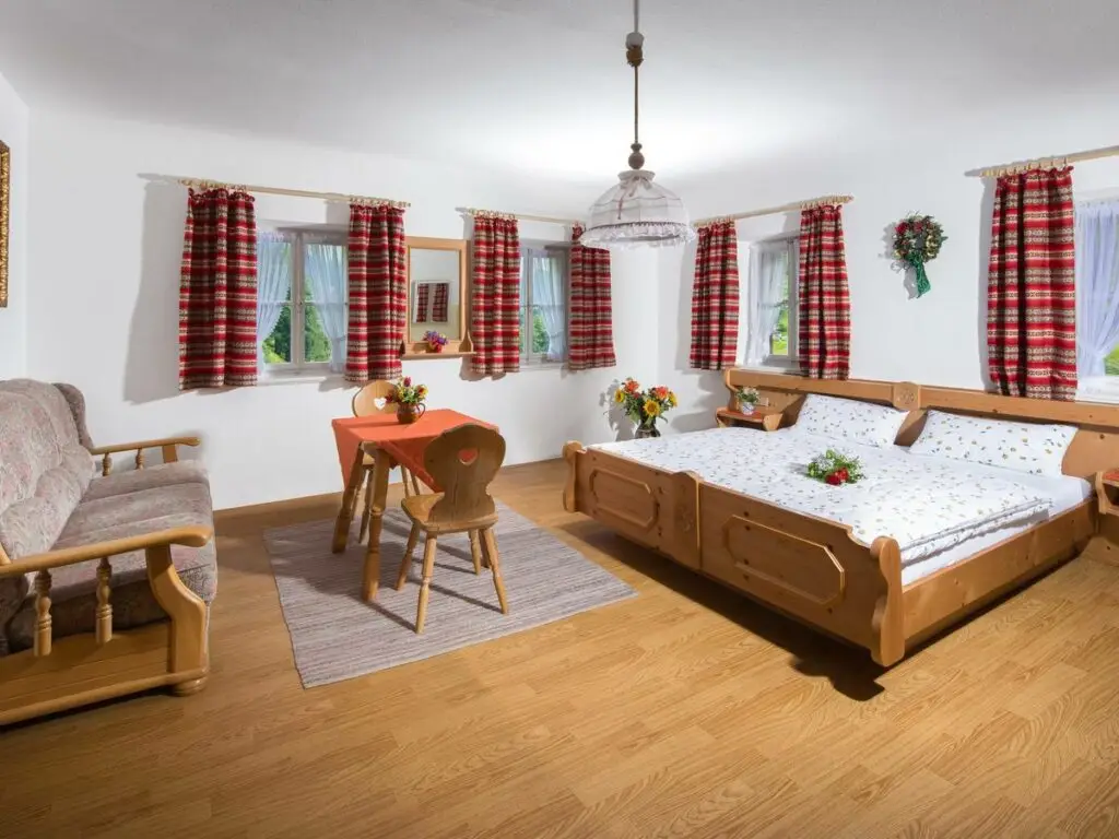 Familienzimmer im Gästehaus Brunnerlehen mit Sitzecke und Doppelbett